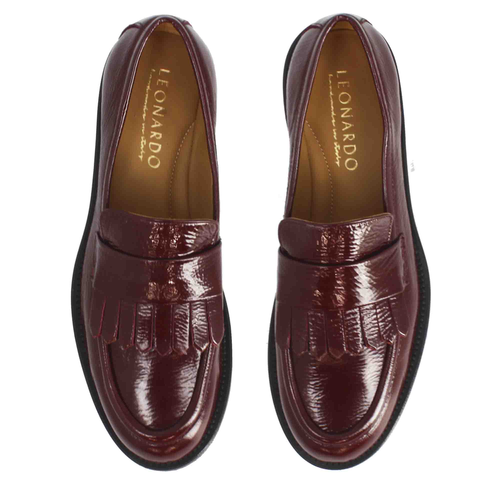 Women's fringed moccasin in shiny leather in burgundy color handmade in Italy