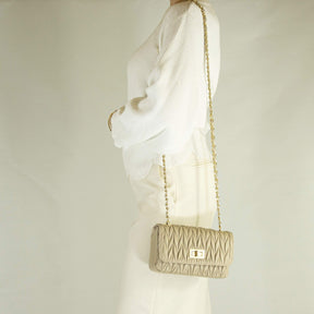Women's handbag in beige leather with jewel shoulder strap
