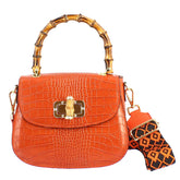 Handmade women's handbag in orange leather with removable shoulder strap
